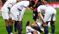 Paris Saint-Germain's French midfielder Desire Doue reacts in pain after suffering an injury during the French L1 football match between FC Lorient and Paris Saint-Germain (PSG) at the Stade du Moustoir in Lorient, western France, on October 29, 2025. (Photo by Jean-Francois Monier / AFP)

