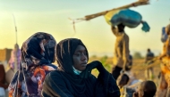 A displaced woman rests in Tawila, in the country's war-torn western Darfur region, on October 28, 2025, after fleeing El-Fasher following the city's fall to the Rapid Support Forces (RSF). (Photo by AFP)

