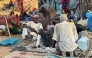 Displaced Sudanese who fled El-Fasher after the city fell to the Rapid Support Forces (RSF), rest near the town of Tawila in war-torn Sudan's western Darfur region on October 28, 2025. Photo by STR / AFP.