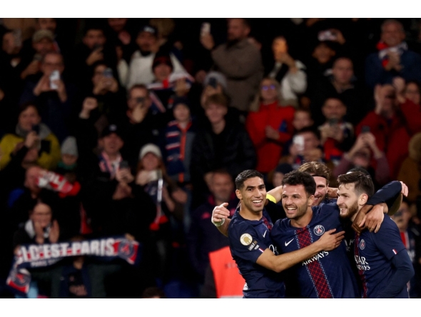 Paris Saint-Germain's Portuguese forward #09 Goncalo Ramos (C) celebrates scoring his team's first goal with Paris Saint-Germain's Moroccan defender #02 Achraf Hakimi (L) and Paris Saint-Germain's Georgian forward #07 Khvicha Kvaratskhelia (R) during the French L1 football match between Paris Saint-Germain (PSG) and OGC Nice at the Parc des Princes stadium in Paris on November 1, 2025. (Photo by FRANCK FIFE / AFP)