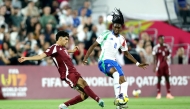 Qatar's Adam Friakh (left) and Italy's Destiny Elimoghale vie for the ball possession. 