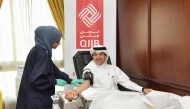 QIIB CEO, Dr. Abdulbasit Ahmad Al-Shaibei during the blood donation campaign