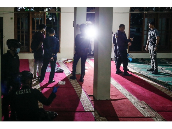 Police officials carry out an on-site investigation following a blast at a mosque inside a school in Jakarta on November 7, 2025. (Photo by CANDRA / AFP)

