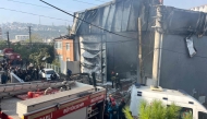 Rescuers and firefighters working at the site of a perfume warehouse where a fire broke out in the Dilovasi district of Kocaeli. Photo by Handout / DHA-Demiroren News Agency / AFP