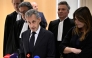 Former French president Nicolas Sarkozy speaks to the press flanked by his wife Carla Bruni and French lawyer Jean-Michel Darrois after the verdict in his trial at the Tribunal de Paris courthouse in Paris, on September 25, 2025. Photo by Julien De Rosa / AFP