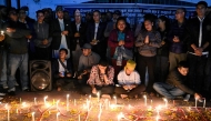 Family members of those killed in September anti-corruption protests take part in a candlelight vigil in front of the fire-damaged parliament building in Kathmandu on November 9, 2025. (Photo by Prakash Mathema / AFP)
