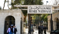 (Files) Youngsters walk outside Syria's National Museum as it reopens to visitors, in Damascus, on January 8, 2025. (Photo by Louai Beshara / AFP)