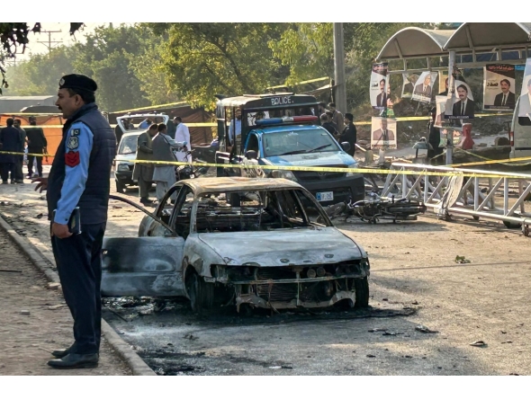 Policemen examine damaged vehicles after a suicide blast outside the district court in Islamabad on November 11, 2025. (Photo by Zain Zaman JANJUA / AFP)
