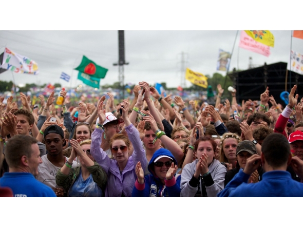 Festival goers attend concerts at the Pyramid Stage during the third day of the Glastonbury Festival of Contemporary Performing Arts near Glastonbury, southwest England, on June 28, 2013. Photo by ANDREW COWIE / AFP