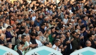 Iranians perform a prayer for rainfall at the Saleh Shrine in Tehran on November 14, 2025, as the country suffers from severe water shortages. Authorities in Tehran warned last week of possible rolling cuts to water supplies in the capital amid what officials call the worst drought in decades. (Photo by AFP) 