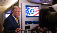 US President Donald Trump speaks to members of press aboard Air Force One on November 14, 2025 while in flight from Washington, DC to West Palm Beach International Airport. Roberto Schmidt/Getty Images/AFP 
