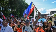 Protesters wave flags and shout slogans during an anti-corruption rally in Quezon City, Metro Manila on November 16, 2025. (Photo by Jam STA ROSA / AFP)