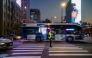 Vehicles drive past a traffic policeman in the Gwanghwamun district of Seoul on November 7, 2025. (Photo by ANTHONY WALLACE / AFP)