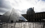 Tourists queue to enter the Louvre museum next to the Louvre pyramid designed by Chinese-US architect Ieoh Ming Pei, in Paris, on November 3, 2025. A gallery in the Louvre was closed to the public due to the building's 
