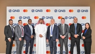 QNB and Mastercard senior executives pose for a goup photo during the signing ceremony.