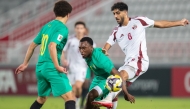 Qatar's Jassem Gaber (right) vies for the ball with Zimbabwe players.