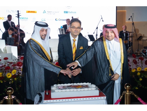 Minister of Public Health, H E Mansoor bin Ebrahim bin Saad Al Mahmoud; Director of the Protocol Department at MoFA, H E Ibrahim Yousif Abdullah Fakhro; and Ambassador of Germany to Qatar H E Oliver Owcza cutting the cake to celebrate  the Day of German Unity. 