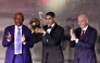 Paris Saint-Germain's Moroccan defender Achraf Hakimi (C) holds his Africa Player of the Year award next to CAF President Patrice Motsepe (L) and FIFA President Gianni Infantino (R) during the 2025 Confederation of African Football (CAF) Awards in Sale, Morocco on November 19, 2025. Photo by Abdel Majid Bziouat / AFP