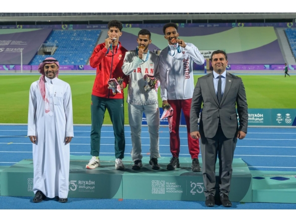 Qatar's Abubaker Haydar (right) celebrates with the gold and silver medal winners on the podium.
