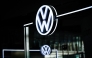 The illuminated VW Logo is pictured in the customer centre at the headquarters of German carmaker Volkswagen (VW) in Wolfsburg, central Germany, on November 21, 2025. (Photo by Ronny Hartmann / AFP)
