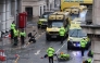 Police officers investigate the scene of an incident in Water Street, on the sidelines of an open-top bus victory parade for Liverpool's Premier League title win, in Liverpool, north-west England on May 26, 2025. (Photo by Darren Staples / AFP)

