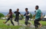 Children play football in a flooded field following rain in Jantho, Aceh province on November 24, 2025. (Photo by Chaideer Mahyuddin / AFP)