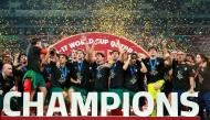 AFP photo of Portugal's players celebrate with the trophy on the podium after the FIFA U17 World Cup final football match between Portugal and Austria at Khalifa International Stadium in Al-Rayyan on November 27, 2025.
