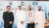 Qatar Chess Federation President Mohammed Al Mudahka poses for picture with International Master Hussein Aziz, who won open blitz bronze. 