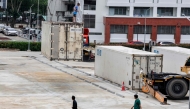 Refrigerated containers are installed to store the bodies of flood victims outside Songklanagarind Hospital in Hat Yai in Thailand's southern Songkhla province on November 28, 2025. (Photo by Sarot Meksophawannakul / Thai News Pix / AFP)
