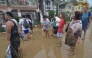 Residents stand in the mud as they wait to be evacuated from their flood-hit homes after Typhoon Kalmaegi hit Cebu City in the central Philippines on November 4. Photo by Alan Tangcawan / AFP