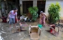 Residents salvage their belongings at an inundated house following flash floods in the aftermath of Cyclone Ditwah, in Wellampitiya on the outskirts of Colombo on December 3, 2025. (Photo by Ishara S. Kodikara / AFP)