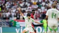 Algeria's Redouane Berkane (foreground) controls the ball.