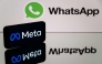 This photograph taken on January 12, 2023 in Toulouse, southwestern France shows a smartphone and a computer screen displaying the logos of WhatsApp app and its parent company Meta. Photo by Lionel BONAVENTURE / AFP