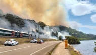 Trains have stopped running on the Central Coast and Newcastle line after a fire broke out on Nimbin Road at Koolewong. (Pics: ABC News)