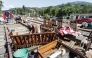 A flood victim restores his belongings in the aftermath of Cyclone Ditwah, along railway tracks in Kandy on December 6, 2025. (Photo by AFP)