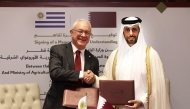 Minister of Municipality H E Abdullah bin Hamad bin Abdullah Al Attiyah and Minister of Foreign Affairs of the Oriental Republic of Uruguay H E Mario Lubetkin exchange documents after signing the MoU. 
