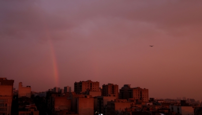 A general view of a rainbow at sunset following several days of rain in the Iranian capital Tehran on December 10, 2025. (Photo by Atta Kenare / AFP)