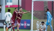 Qatar players celebrate a goal yesterday.