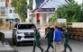 Cambodian police officials walk at the closed Poipet International border checkpoint between Cambodia and Thailand in Poipet, Banteay Meanchey province on December 12, 2025, amid clashes along the Cambodia-Thailand border. (Photo by Tang Chhin Sothy / AFP)