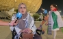 A Palestinian woman and child injured during the Gaza war speak during the Palestine-Saudi Arabia match of the FIFA Arab Cup Qatar at Lusail Stadium on Thursday. 