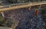 An aerial view shows protesters at Shahbagh intersection in Dhaka on December 19, 2025, following the death of youth leader Sharif Osman Hadi. (Photo by Abdul Goni / AFP)