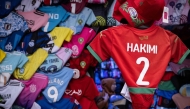 Morocco defender Achraf Hakimi's jersey is displayed in a shop in Rabat, on December 19, 2025, ahead of the Africa Cup of Nations (AFCON). (Photo by Sebastien Bozon / AFP)