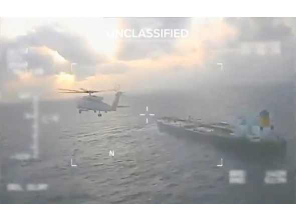 This screen grab taken from a video posted on the X account of US Secretary of Homeland Security Kristi Noem shows a US Coast Guard aircraft flying over a crude oil tanker, last docked in Venezuela, before apprehending it on December 20, 2025. (Photo by Handout / US Secretary of Homeland Security Kristi Noem's X account / AFP) 