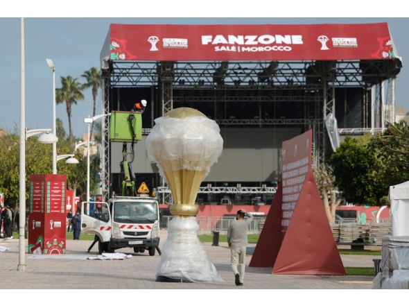 Workers put the finishing touches on the fanzone, in the Souissi district of Rabat, Morocco on December 20, 2025, ahead of the start of the Africa Cup of Nations (CAN) football tournament. (Photo by Abdel Majid BZIOUAT / AFP)
