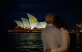 The Sydney Opera House is illuminated with candlelights in Sydney on December 21, 2025, as part of a national day of reflection honouring the victims of the Bondi Beach terrorist attack. (Photo by George Chan / AFP)