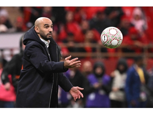 Morocco's head coach Walid Regragui throws a ball during the Africa Cup of Nations (CAN) group A football match between Morocco and Comoros at Prince Moulay Abdellah Stadium in Rabat on December 21, 2025. (Photo by Sebastien Bozon / AFP)