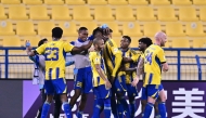 Al Gharafa players celebrate after Seydou Sano scored the late winner.