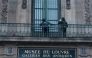 Workers install iron window guards on the window of the Gallerie d'Apollon (Apollo's gallery) of the Louvre Museum, on the Quai Francois Mitterrand side, in Paris on December 23, 2025 a few weeks after thieves used a furniture lift to break into the museum. Photo by Dimitar DILKOFF / AFP