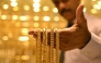 (Files) A salesman displays gold chains at a jewellery store in Bengaluru on September 17, 2025. (Photo by Idrees Mohammed / AFP)