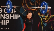 Qatari weightlifter Sarah Al-Qubaisi competes during the women’s 77 kg category event.
